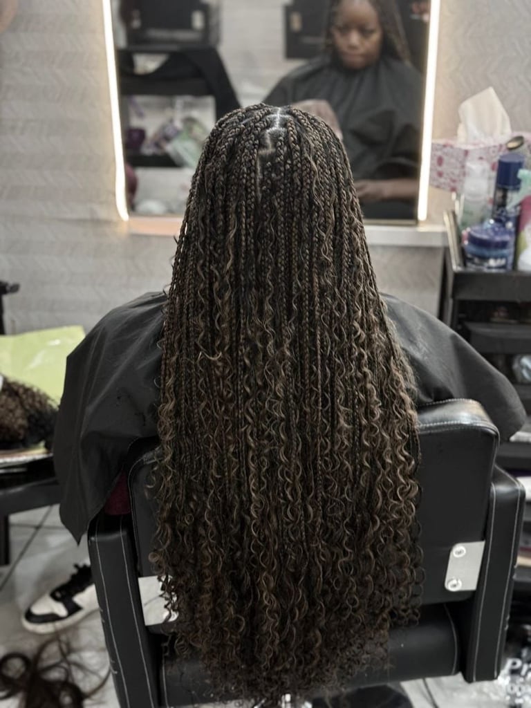 Person with long braided hair in salon chair